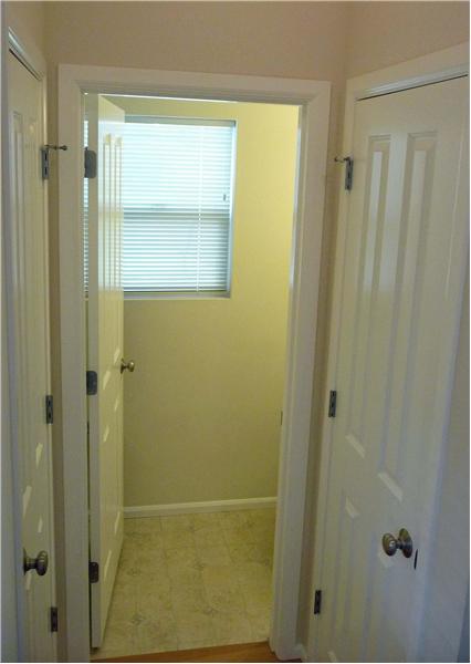 Powder room off entry along with coat closet and linen closet.