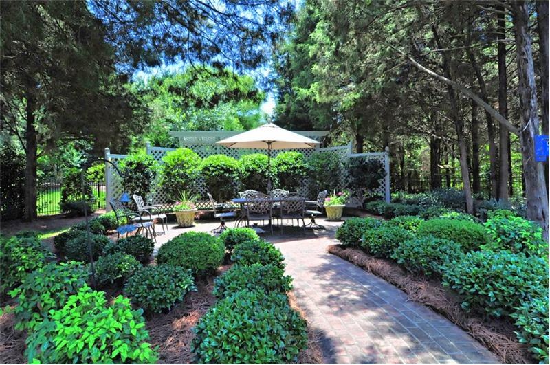 Brick paver walk-way leads to the large paver patio